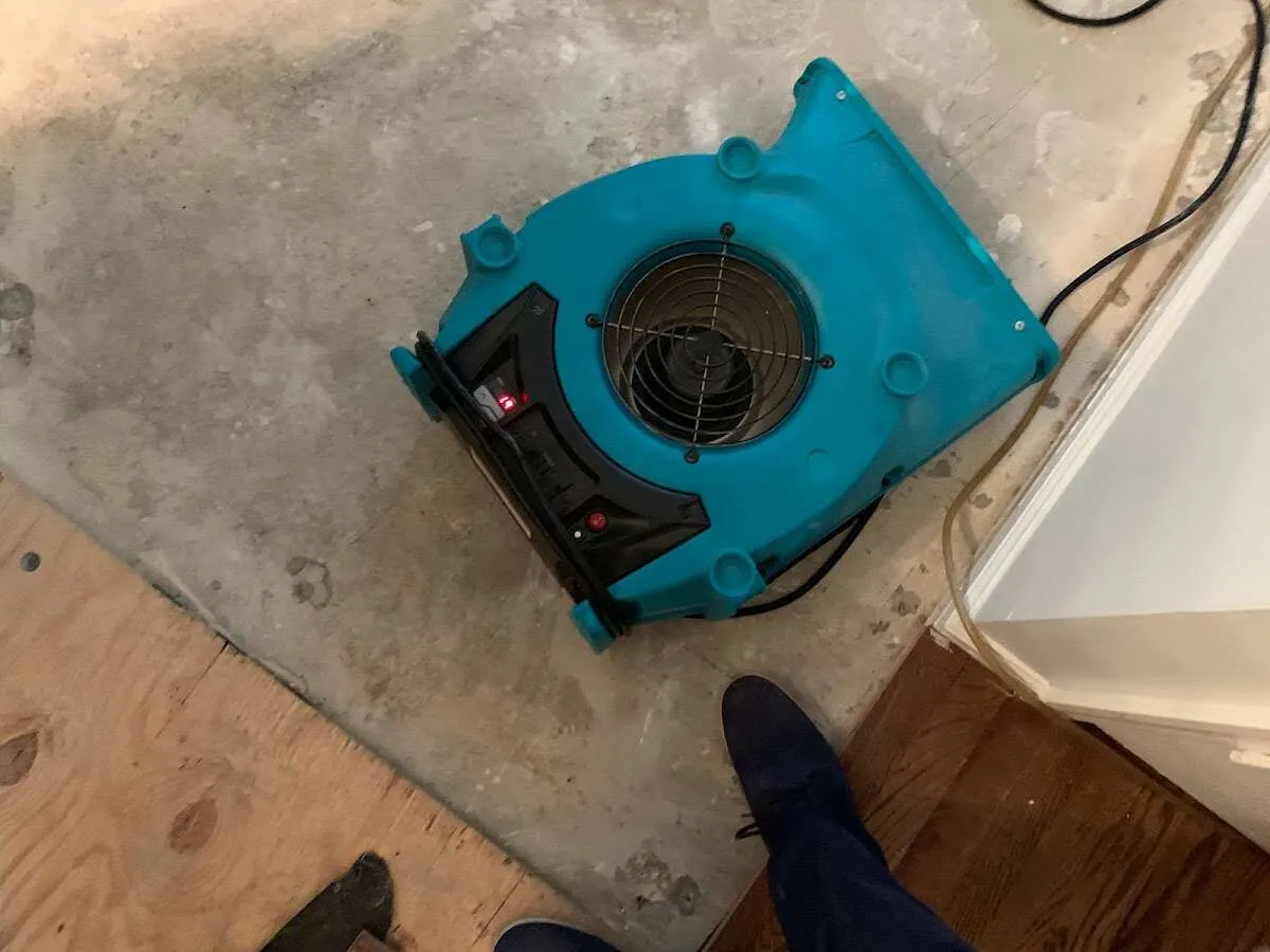 Air mover drying subfloor during Leak Detection & Repair in Cleveland Heights